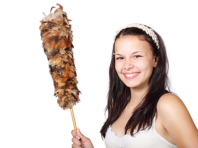 woman in white and beige spaghetti strap shirt holding feather duster thumbnail