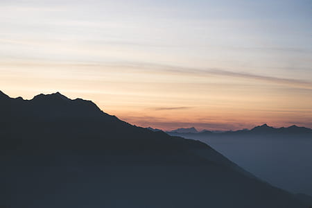 silhouette photography of mountain with fogs thumbnail