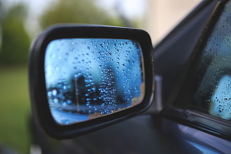 selective focus photography of vehicle side mirror with water droplets thumbnail