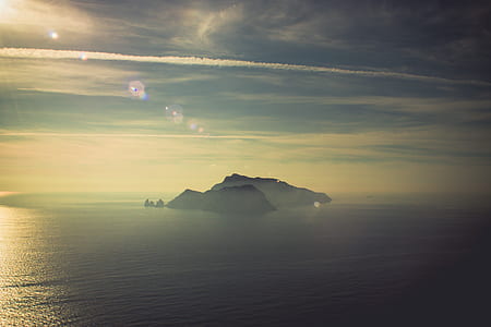 island mountain covered with smoke at daytime thumbnail