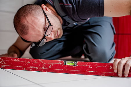 man holding spirit level thumbnail
