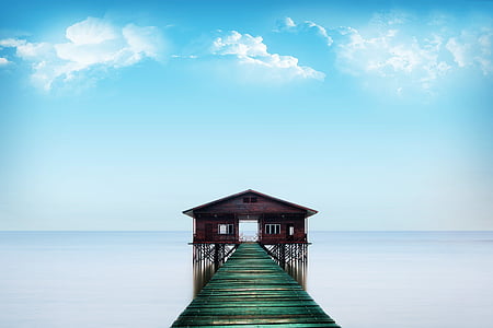 brown dock leading to house near body of water thumbnail