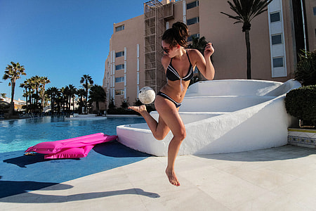 Woman playing with soccer ball at a resort thumbnail