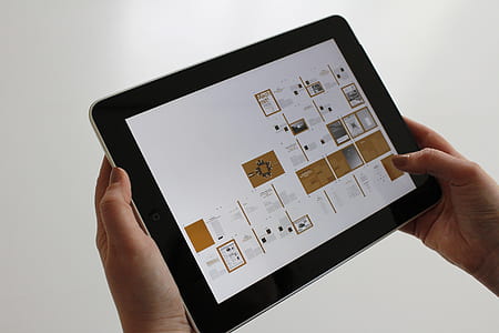 woman holding black iPad thumbnail