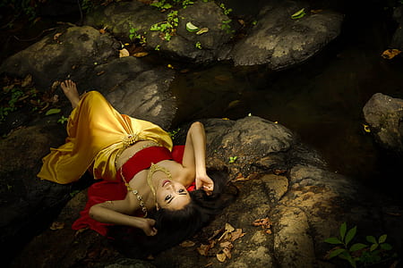 woman lying on gray stone thumbnail