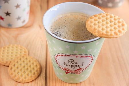 biscuit on green cup filled with coffee thumbnail