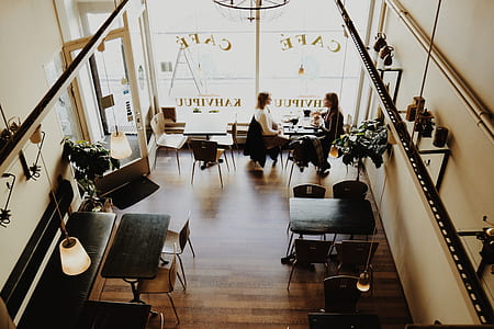 two woman sitting near black table and chair thumbnail