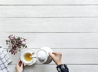 person holding tea set thumbnail