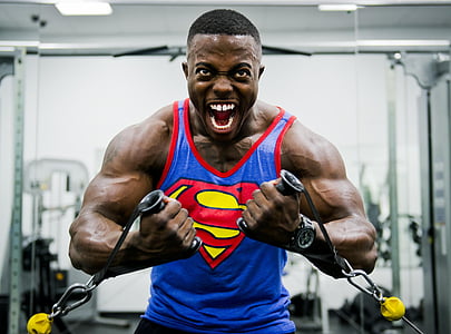man wearing blue and yellow Superman tank top thumbnail