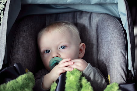 baby sitting on gray pad thumbnail