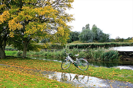 white road bike beside of lake thumbnail