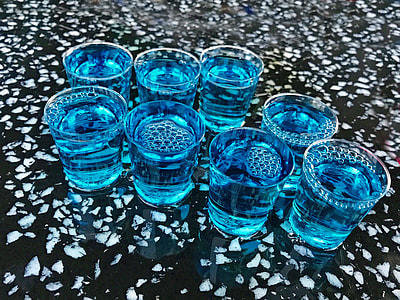 shot glass filled with blue liquid thumbnail