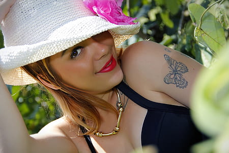 smiling woman wearing hat and black halter top thumbnail
