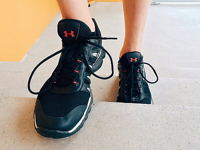 person wearing black Under Armour shoes on stairs thumbnail