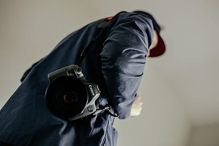 Canon DSLR camera on mans shoulder thumbnail