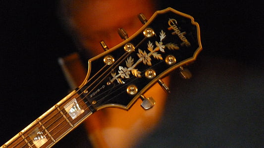 shallow focus photography of black Epiphone guitar head stock thumbnail