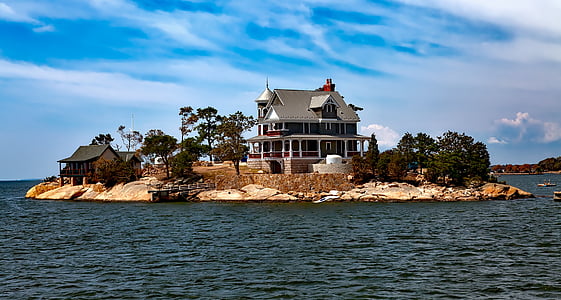 landscape photography of island with white and gray house during daytime thumbnail