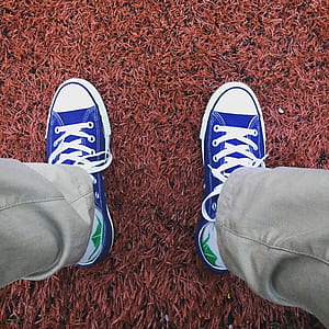person wearing blue-and-white low-top sneakers and khaki pants thumbnail