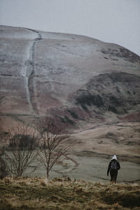 person walking on hill at daytime thumbnail