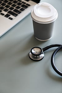 black and gray stethoscope beside white and gray cup thumbnail