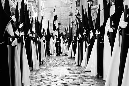 group of person with cone hat and robe standing along ally thumbnail
