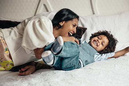 Mother Tickling Her Son Photo thumbnail