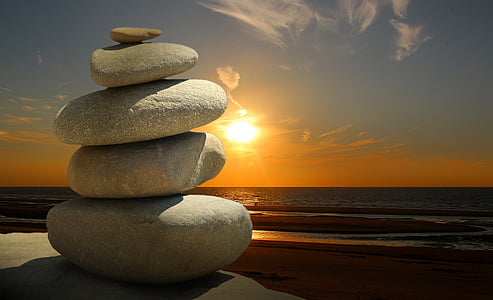 pile of stones on sunset near the seashore thumbnail