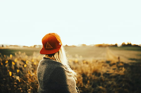 Woman Wearing Gray Shirt With Cap Under White Sky thumbnail