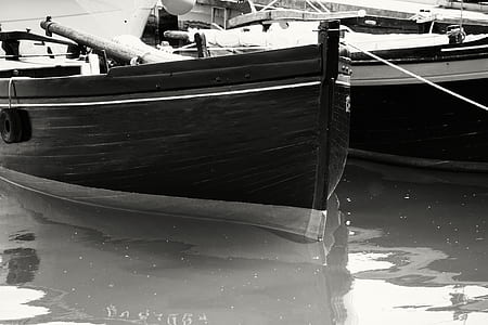 Gray Scale Photo of Boat on Body of Water thumbnail