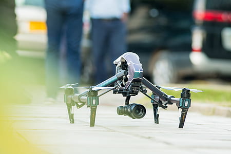 Gray and Green Quadcopter Drone on Ground thumbnail