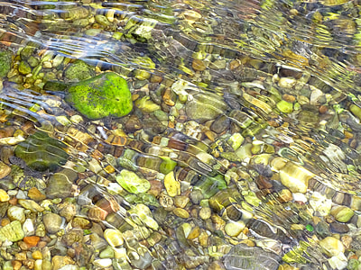 assorted stone pebbles in clear water thumbnail