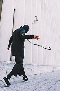 man walking beside building thumbnail