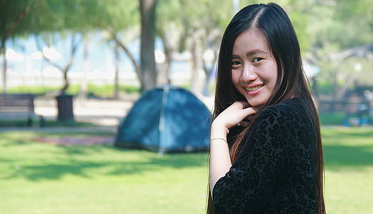 woman standing near camping tent thumbnail