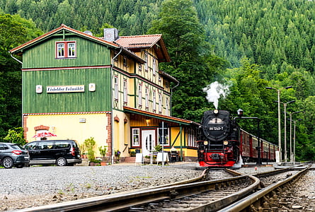 red and black steam train on railways during daytime thumbnail