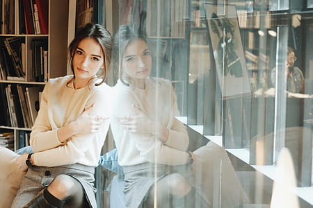 woman posing beside glass thumbnail