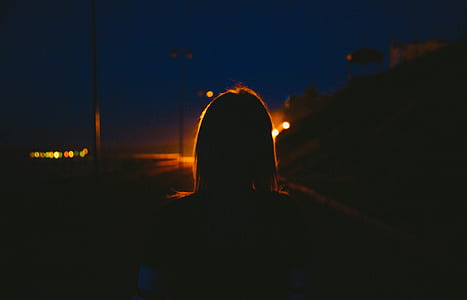 woman facing lights in the middle of road thumbnail