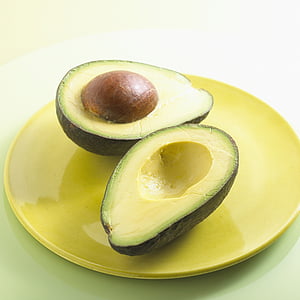 slice avocado fruit on round yellow plate thumbnail