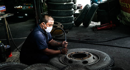 man inflating vehicle tire thumbnail