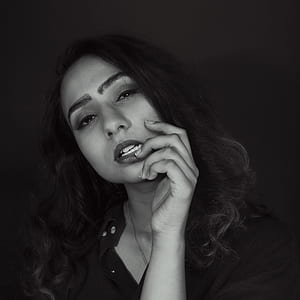 Woman in Black Top Touching Her Bottom Lip thumbnail