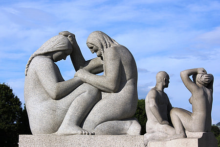 man and woman concrete statues during daytime thumbnail