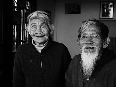 grayscale photo of man and woman near wall thumbnail