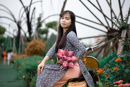 Smiling Woman Wearing Grey and Multicolored Floral Long-sleeved Dress thumbnail