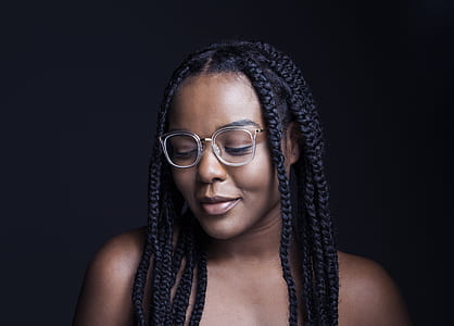 woman wearing white framed eyeglasses looking below thumbnail