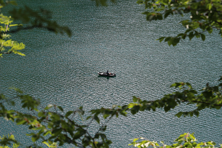 person sailing on brown boat at daytime thumbnail