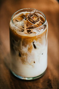 clear drinking glass filled with coffee with ice thumbnail
