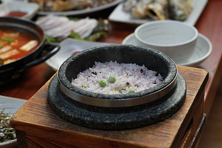 cooked rice in black bowl near white ceramic bowl thumbnail
