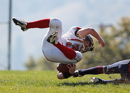 depth of field photography of american football athlete about to fall on ground thumbnail