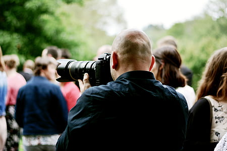 man taking photos using DSLR camera thumbnail