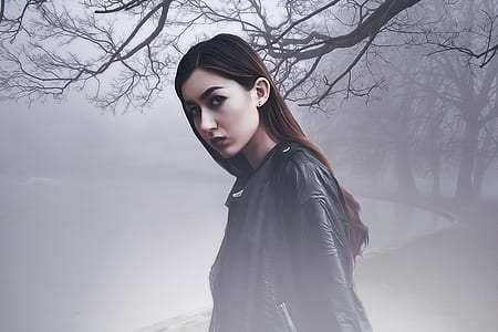 woman wearing black leather jacket standing in dark foggy forest thumbnail