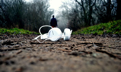 white headphones on brown road thumbnail